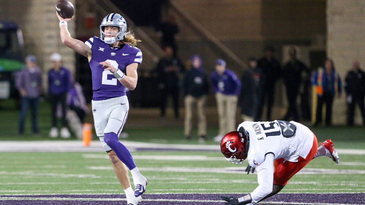 Kansas State Wildcats quarterback Avery Johnson (2) passes the ball while being pressured by Cincinnati Bearcats defensive lineman Kameron Wilson (15) during the third quarter at Bill Snyder Family Football Stadium.