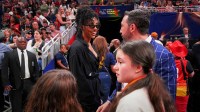 UConn women’s basketball player Azzi Fudd stands courtside during the WNBA All-Star Game.