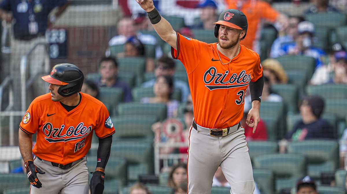 Baltimore Orioles first baseman Ryan O'Hearn (32) and right fielder Ramon Laureano (rear left) react after scoring against the Atlanta Braves during the tenth inning at Truist Park. Mansolino Elias