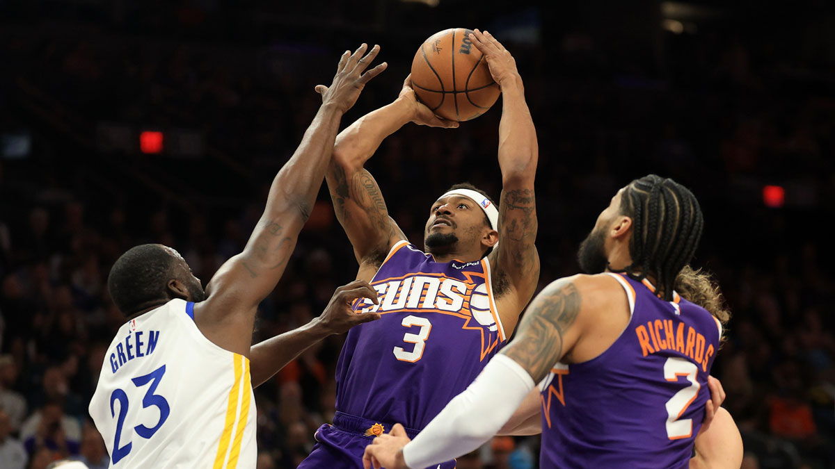 Phoenix Suns guard Bradley Beal (3) shoots the ball against Golden State Warriors forward Draymond Green (23) during the second half at Footprint Center.