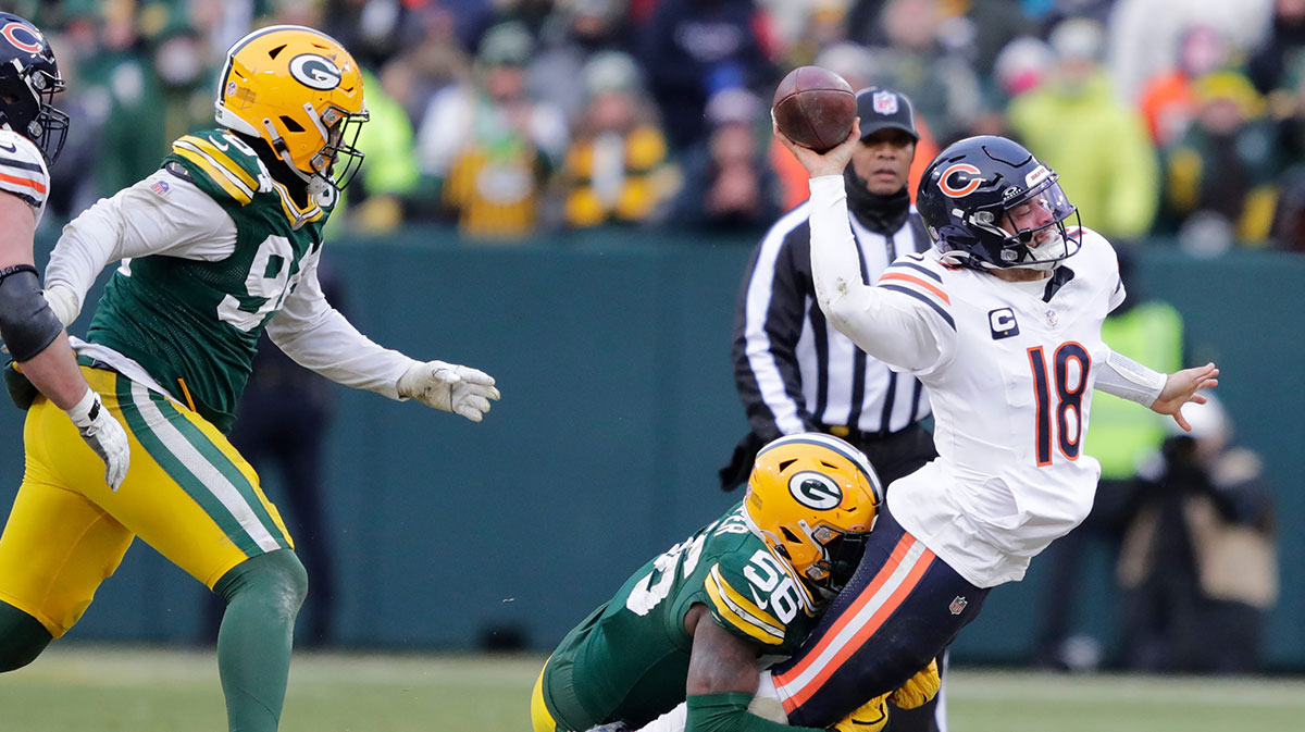 Chicago Bears quarterback Caleb Williams (18) throws an incomplete pass as he is tackled by Green Bay Packers linebacker Edgerrin Cooper (56) in the fourth quarter during their football game Sunday, January 5, 2025, at Lambeau Field in Green Bay, Wisconsin.