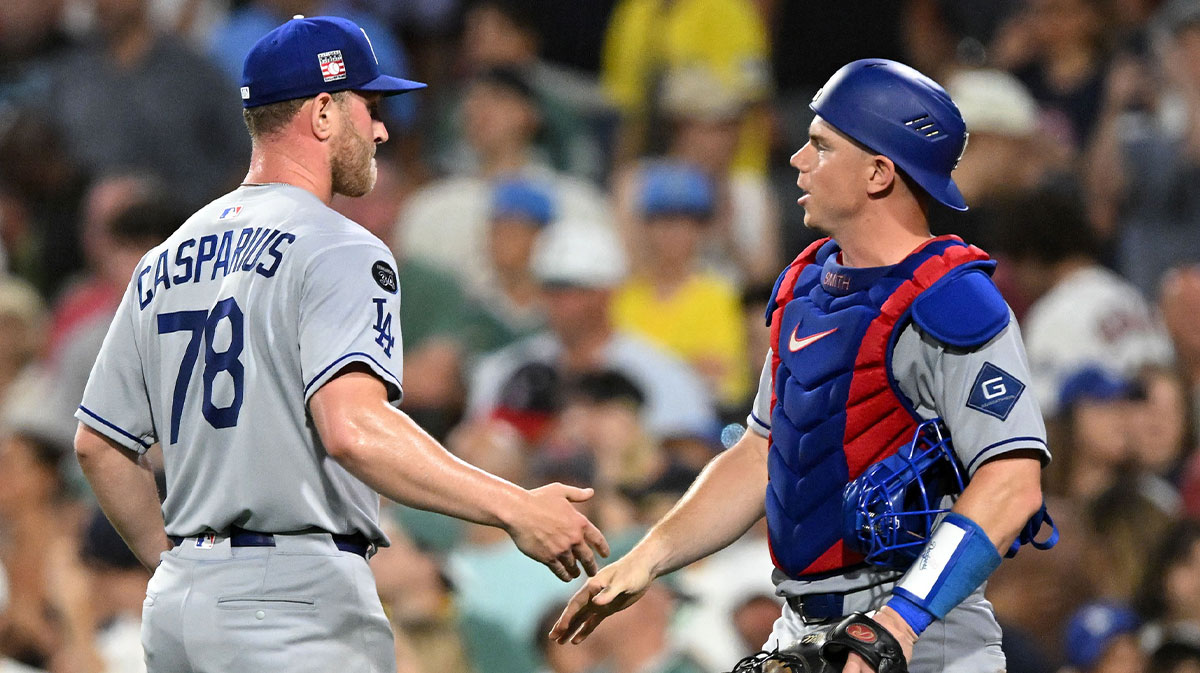 Los Angeles Dodgers relief pitcher Ben Casparius (78) high-fives catcher Will Smith (16) after a game against the Boston Red Sox at Fenway Park.
