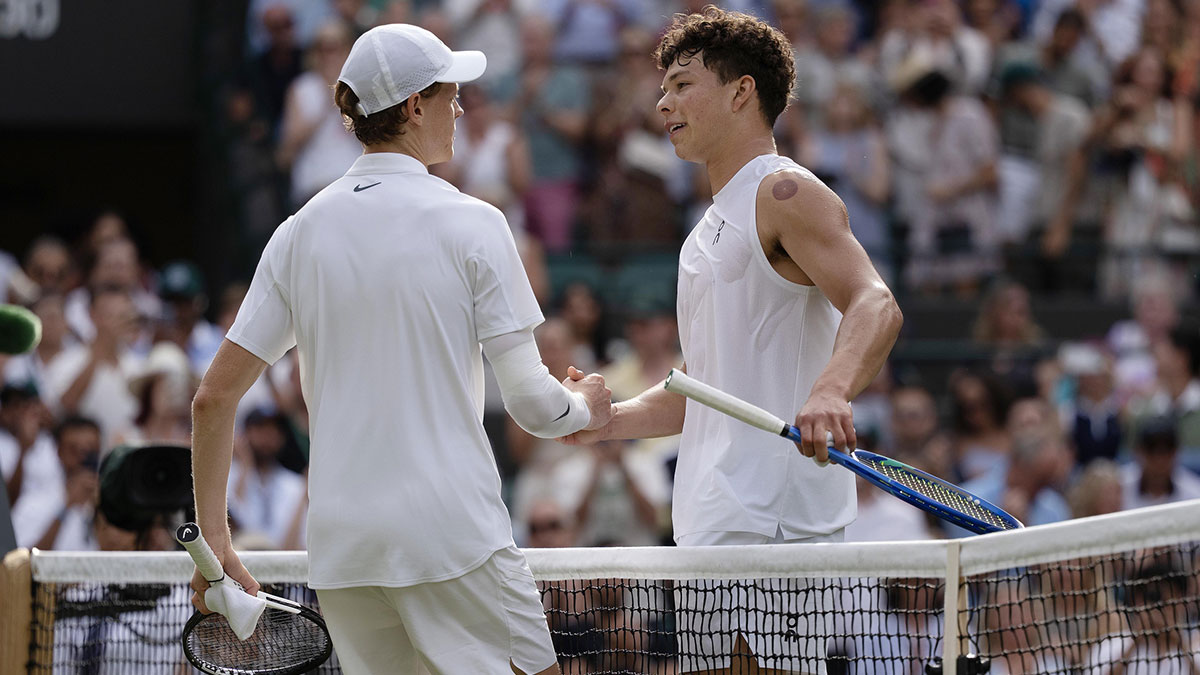 Jannik Sinner of Italy at the net with Ben Shelton of the United States after their match on day 10 at All England Lawn Tennis and Croquet Club.