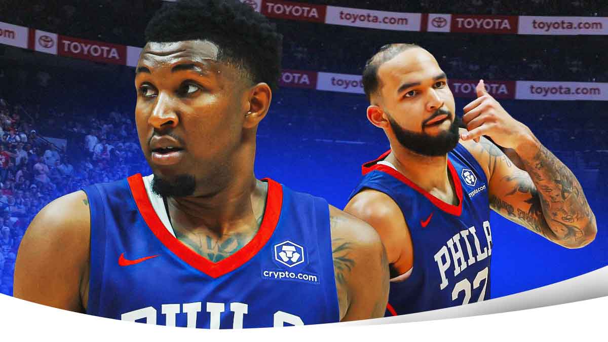 Justin Edwards and Johni Broome in their 76ers uniforms on a basketball court.