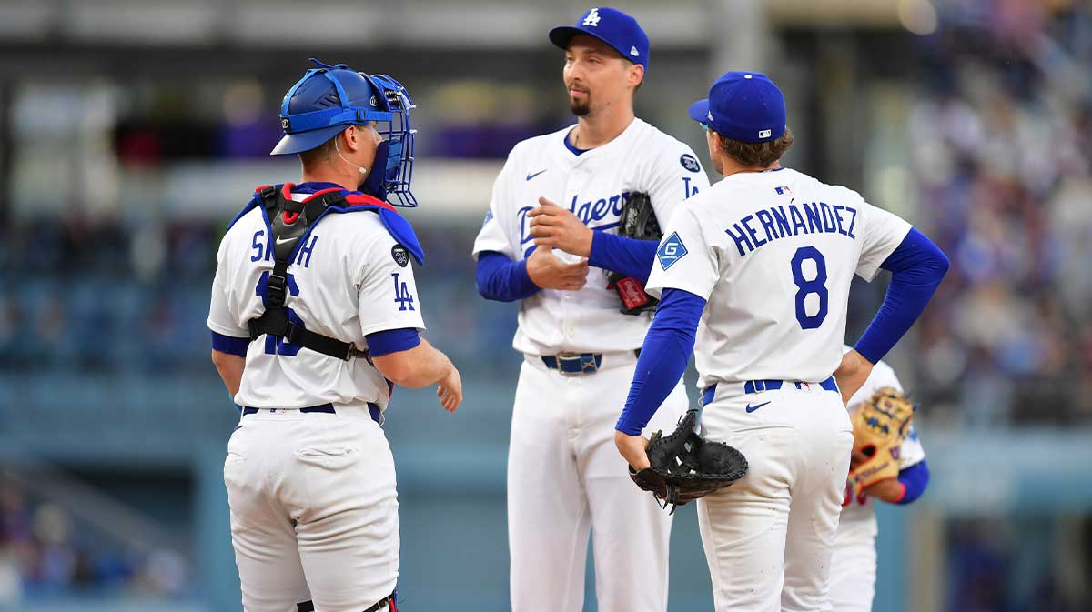 Los Angeles Dodgers pitcher Blake Snell (7) is visited by catcher Will Smith (16) and third baseman Enrique Hernandez (8) during the second inning against the Atlanta Braves at Dodger Stadium.