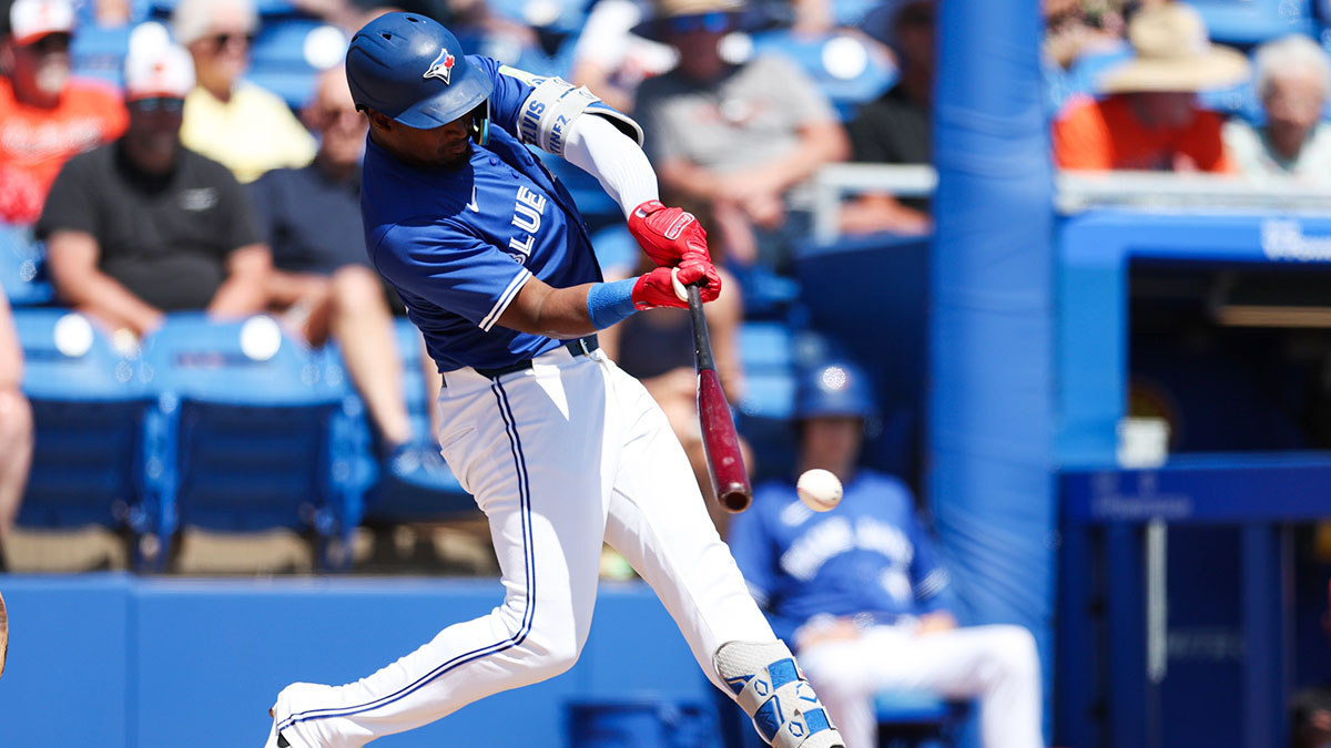 Toronto Blue Jays second baseman Orelvis Martinez (13) hits a base hit against the Baltimore Orioles in the second inning during spring training at TD Ballpark.