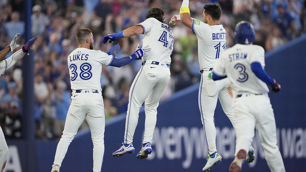 Jul 5, 2025; Toronto, Ontario, CAN; Toronto Blue Jays center fielder Nathan Lukes (38) and shortstop Bo Bichette (11) congratulate right fielder Addison Barger (47) after his walk off single against the Los Angeles Angels during the 11th inning at Rogers Centre.