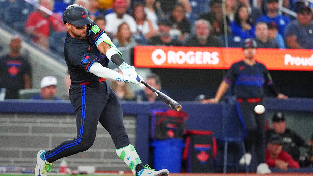 Toronto Blue Jays shortstop Bo Bichette (11) hits an RBI single against the Los Angeles Angels during the sixth inning at Rogers Centre.