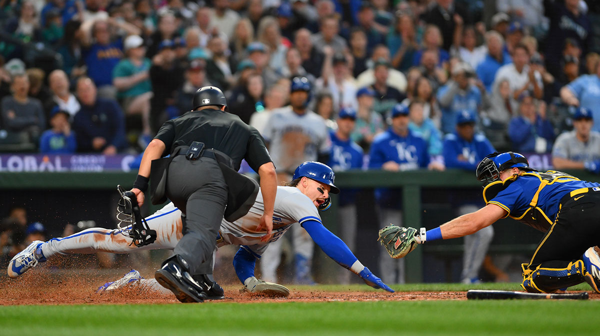 Kansas City Royals shortstop Bobby Witt Jr. (7) scores a run past Seattle Mariners catcher Cal Raleigh (29) during the seventh inning at T-Mobile Park.