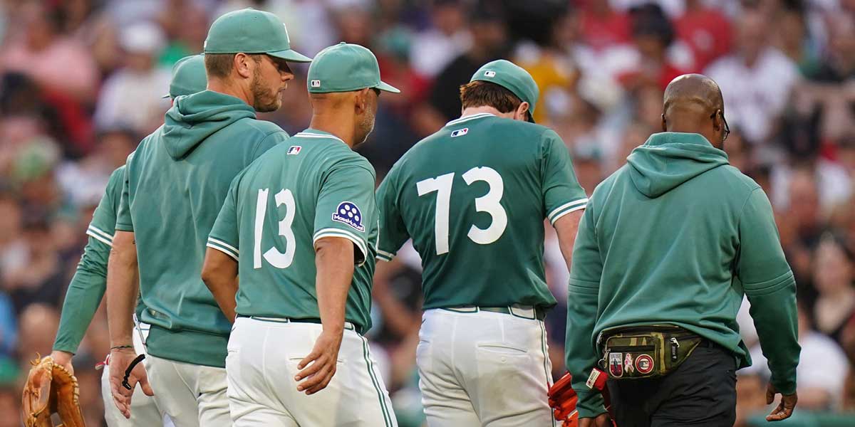 Boston Red Sox pitcher Hunter Dobbins (73) is taken out of the game after being hurt after a play at first against the Tampa Bay Rays in the second inning at Fenway Park.