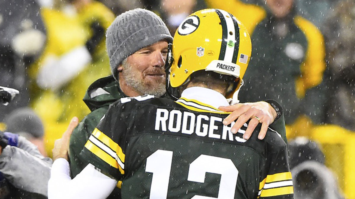 Green Bay Packers legends Brett Favre and Aaron Rodgers, who was with The Office star Brian Baumgartner when Favre announced he was not retiring.