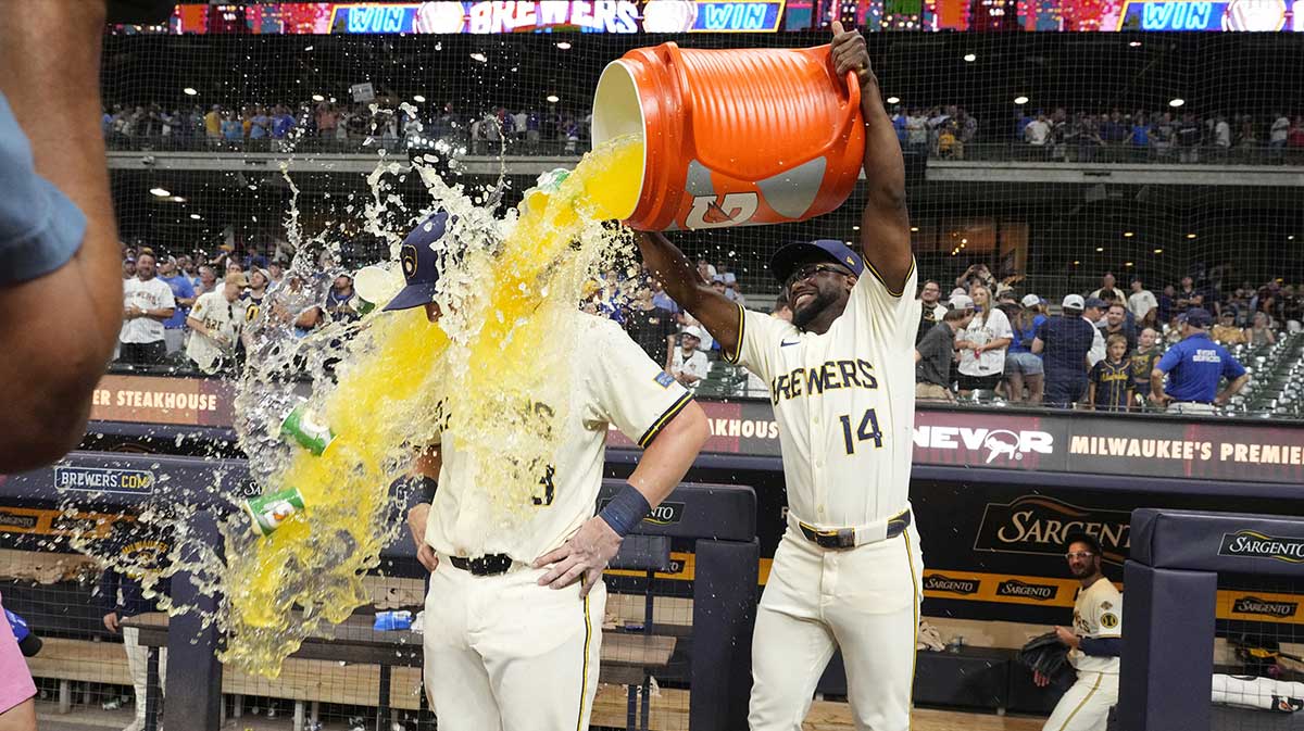 Milwaukee Brewers shortstop Andruw Monasterio (14) dumps Gatorade over Milwaukee Brewers first base Andrew Vaughn (28) head after the game in which Milwaukee Andrew Vaughn (28) hit a grand slam against the Chicago Cubs at American Family Field. Andrew Vaughn joins Barry Bonds in MLB history.