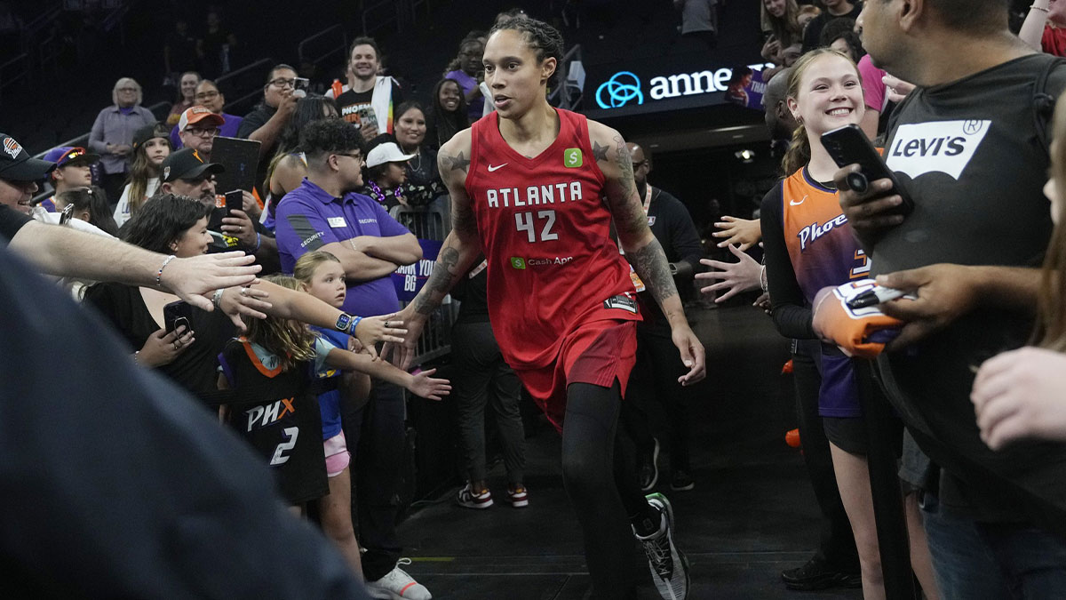 Atlanta Dream center Brittney Griner slaps hands with fans after the Dream defeated the Mercury 90-79 at PHX Arena July 23, 2025.