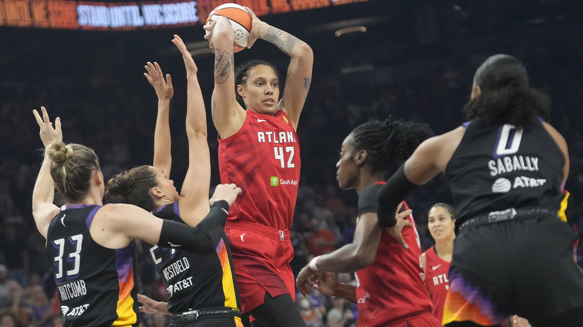 Atlanta Dream center Brittney Griner (42) passes the ball while defended by Phoenix Mercury forward Kathryn Westbeld (24) and guard Sami Whitcomb (33) during the first quarter at PHX Arena Jul 23, 2025.