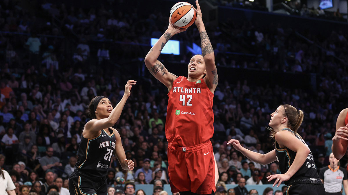 Atlanta Dream center Brittney Griner (42) drives past New York Liberty forward Isabelle Harrison (21) and guard Sabrina Ionescu (20) in the second quarter at Barclays Center.