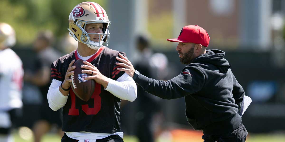San Francisco 49ers quarterbacks coach harasses Brock Purdy (13) in a passing drill during a team OTA at Levi's Stadium.