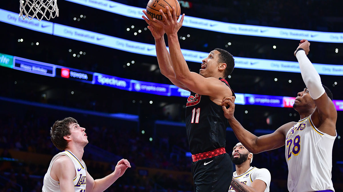 Portland Trail Blazers guard Malcolm Brogdon (11) moves to the basket against Los Angeles Lakers forward Rui Hachimura (28) and guard Austin Reaves (15) during the first half at Crypto.com Arena.