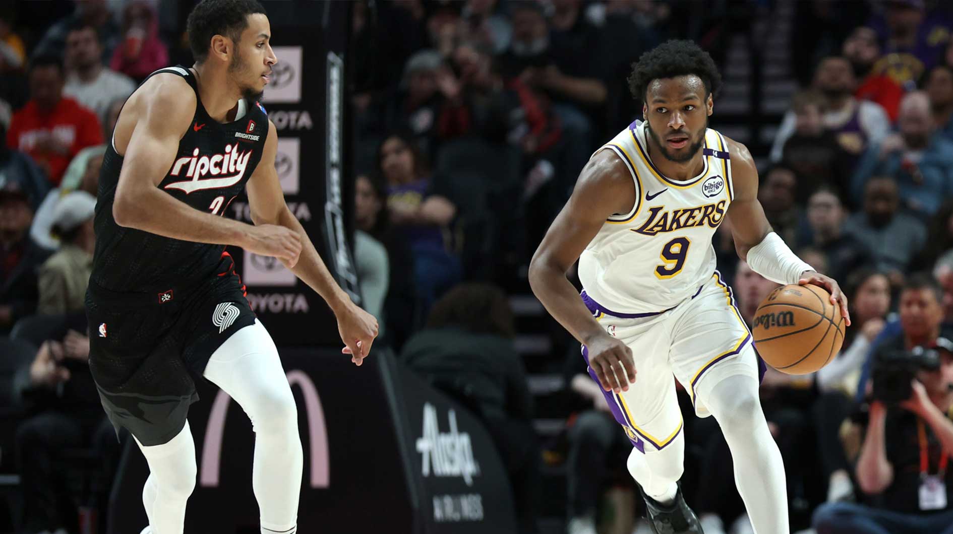 Los Angeles Lakers guard Bronny James (9) brings the ball up the court past Portland Trail Blazers forward Kris Murray (24) in the second half at Moda Center.
