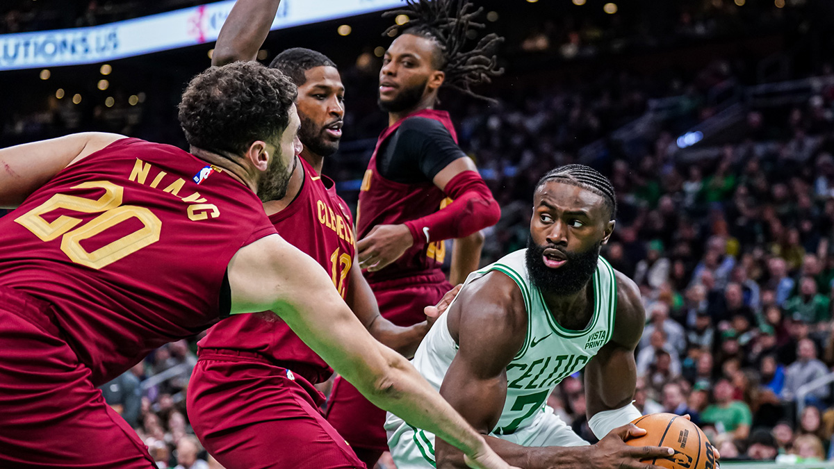 Boston Celtics guard Jaylen Brown (7) looks to pass the ball against Cleveland Cavaliers center Tristan Thompson (12) and forward Georges Niang (20) in the second half at TD Garden.
