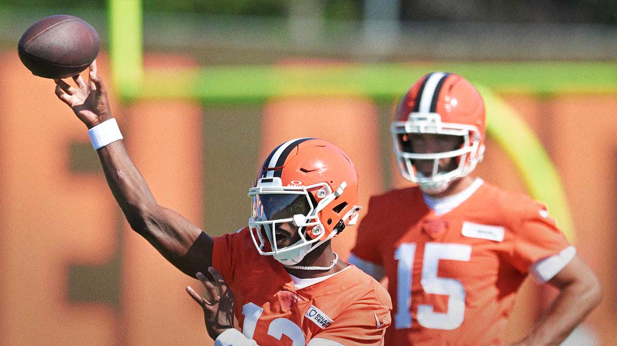 Cleveland Browns quarterback Shedeur Sanders (12) throws a pass as quarterback Joe Flacco (15) looks on during training camp at CrossCountry Mortgage Campus.