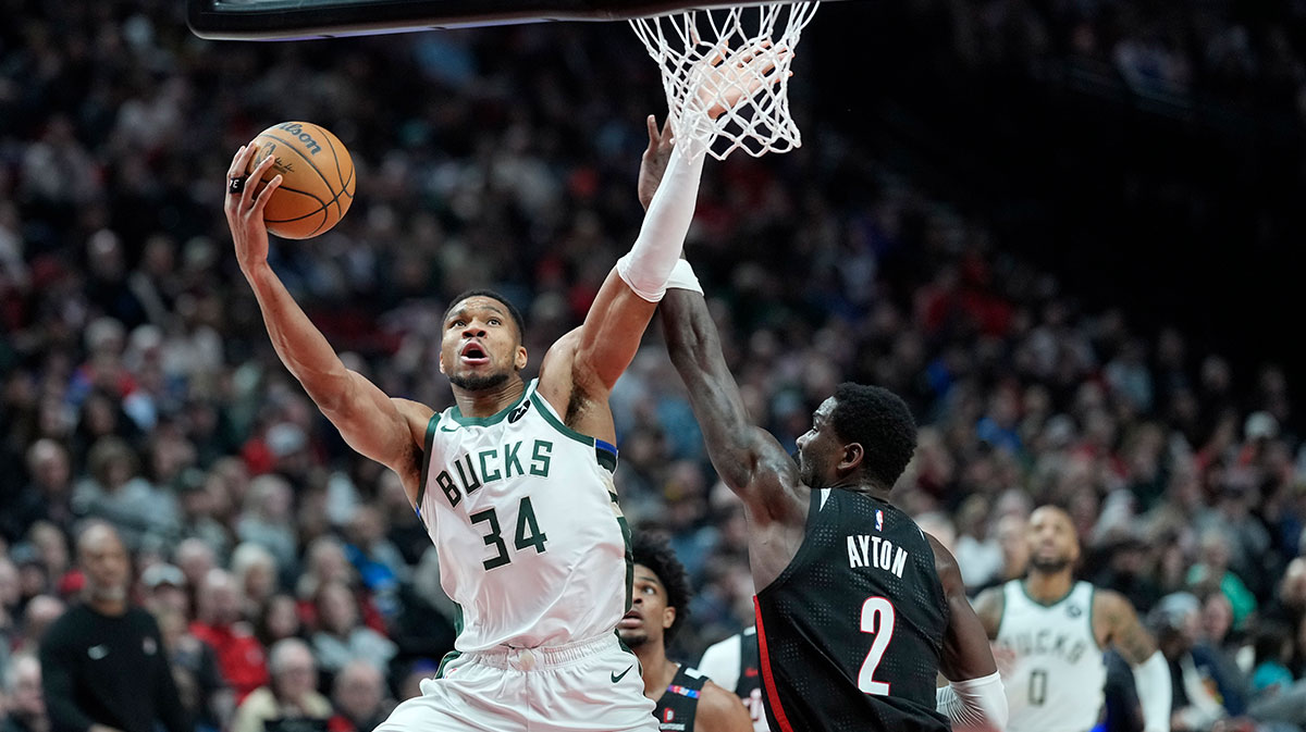 Milwaukee Bucks power forward Giannis Antetokounmpo (34) shoots the ball against Portland Trail Blazers center Deandre Ayton (2) during the second half at Moda Center.