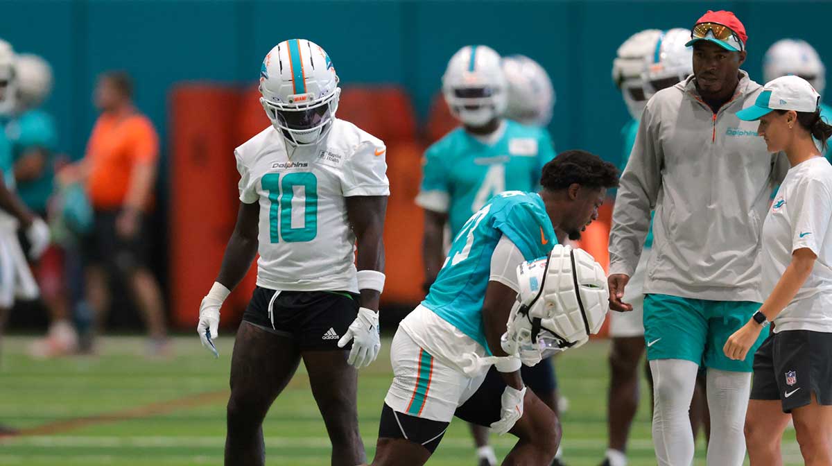 Miami Dolphins cornerback Artie Burns (23) reacts during training camp as wide receiver Tyreek Hill (10) watches at Baptist Health Training Complex.