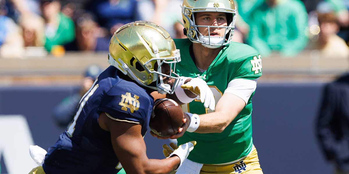 Notre Dame quarterback CJ Carr, right, hands the ball off to running back Kedren Young during the Notre Dame Blue-Gold spring football game at Notre Dame Stadium on Saturday, April 12, 2025, in South Bend.
