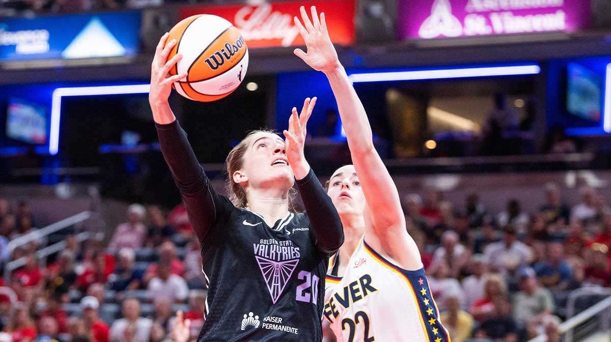 Golden State Valkyries guard Kate Martin (20) shoots the ball while Indiana Fever guard Caitlin Clark (22) defends in the second half at Gainbridge Fieldhouse.