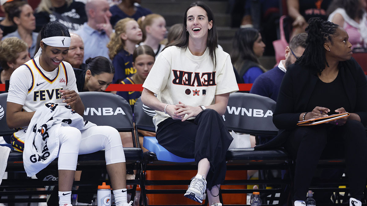 Injured Indiana Fever guard Caitlin Clark (22) looks on from the bench during the first half of a basketball game against the Chicago Sky at United Center.