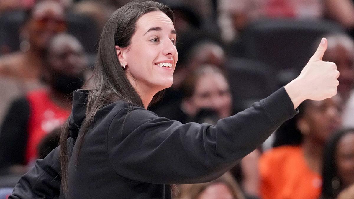 Indiana Fever's Caitlin Clark (22) gives a thumbs up to Los Angeles Sparks's Kelsey Plum (10) after she travels with the ball Saturday, July 19, 2025, during the WNBA All-Star Game at Gainbridge Fieldhouse in Indianapolis.