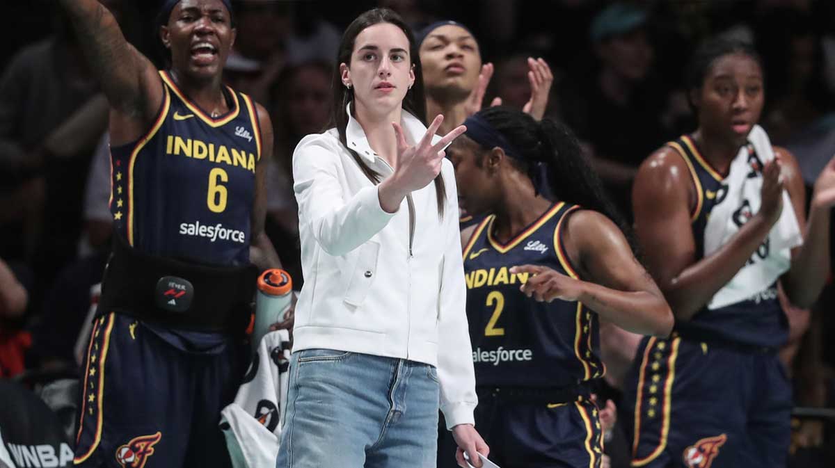 Indiana Fever guard Caitlin Clark (not in uniform) celebrates from the bench in the first quarter against the New York Liberty at Barclays Center.