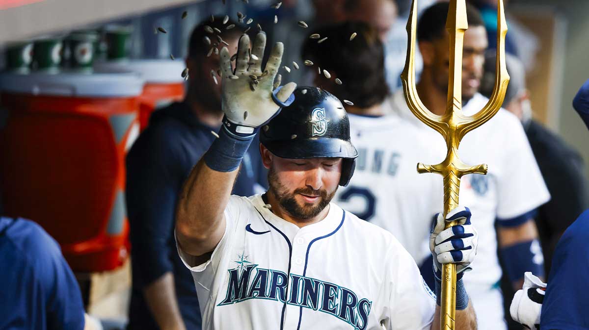 Seattle Mariners catcher Cal Raleigh (29) swats away sunflower seeds thrown by a teammate in the dugout after hitting a solo-home run against the Kansas City Royals during the seventh inning at T-Mobile Park.