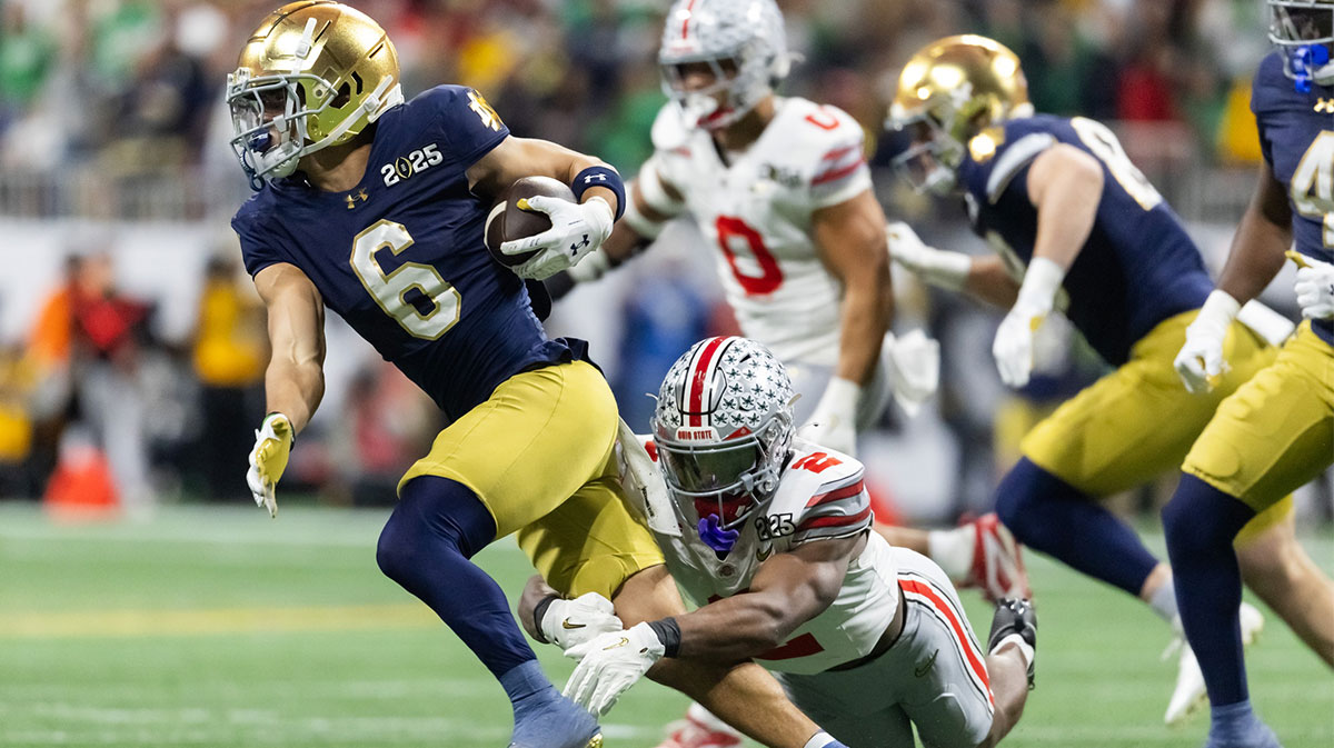Notre Dame Fighting Irish wide receiver Jordan Faison (6) runs the ball against Ohio State Buckeyes safety Caleb Downs (2) during the CFP National Championship college football game at Mercedes-Benz Stadium.