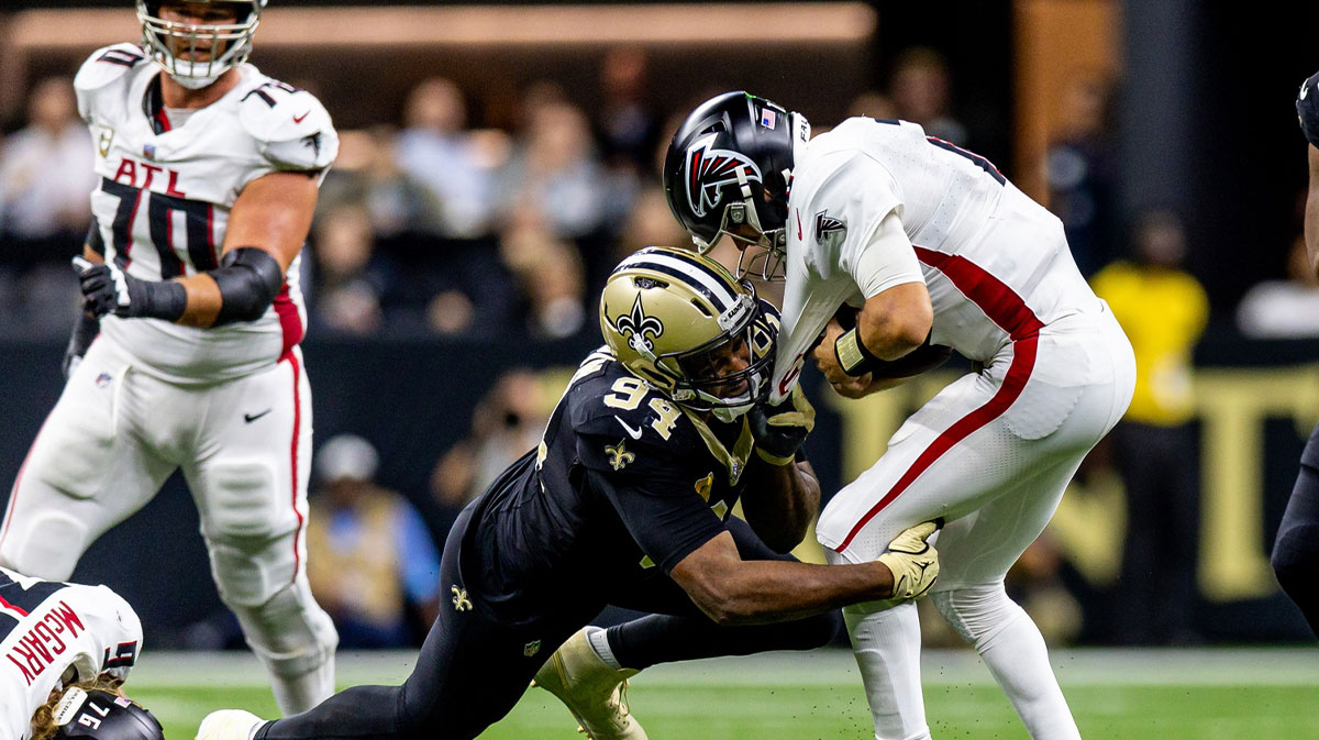 New Orleans Saints defensive end Cameron Jordan (94) leaps over Atlanta Falcons defensive end Khalid Kareem (92) to sack Atlanta Falcons quarterback Kirk Cousins (18) during the second half at Caesars Superdome.