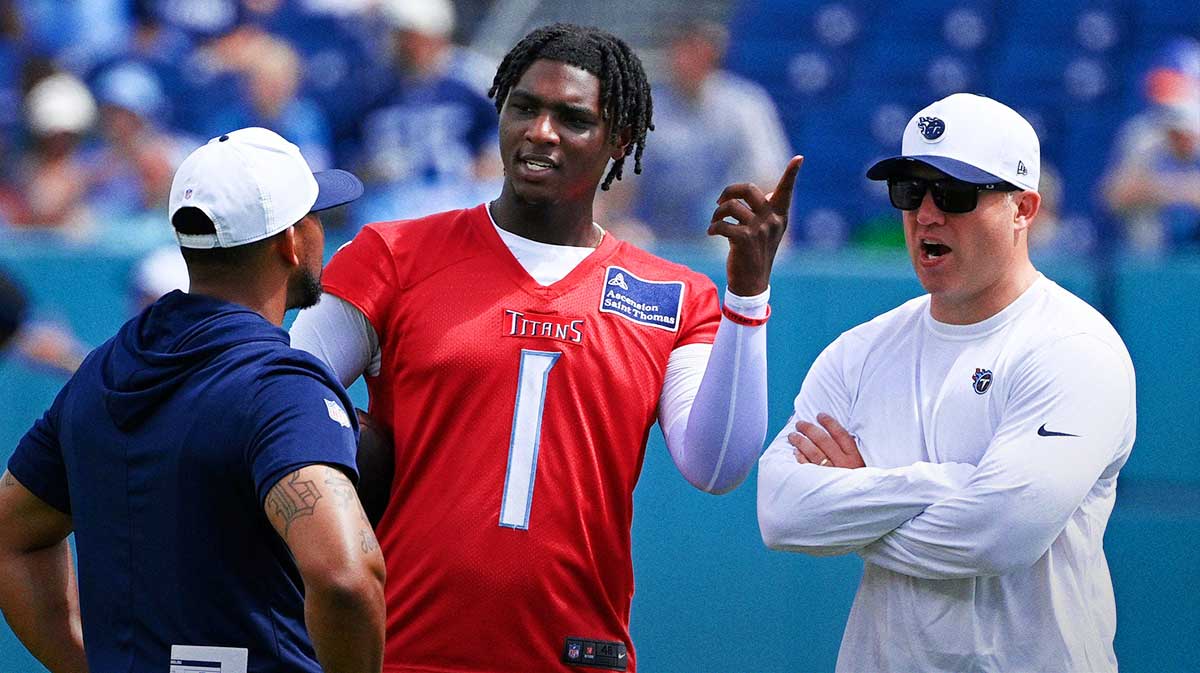 Tennessee Titans quarterback Cam Ward (1) talks with coaches during “Back Together Weekend” training camp practice at Nissan Stadium Saturday, July 26, 2025, in Nashville, Tenn.