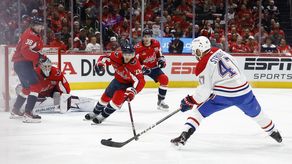 Montreal Canadiens defenseman Jayden Struble (47) shoots the puck on Washington Capitals goaltender Logan Thompson (48) as Capitals center Nic Dowd (26) defends in the second period in game two of the first round of the 2025 Stanley Cup Playoffs at Capital One Arena.