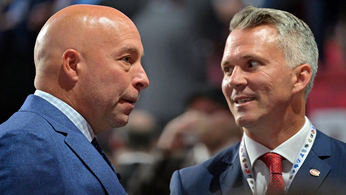Montreal Canadiens general manager Kent Hughes (left) talks with head coach Martin St. Louis before the first round of the 2022 NHL Draft at Bell Centre.
