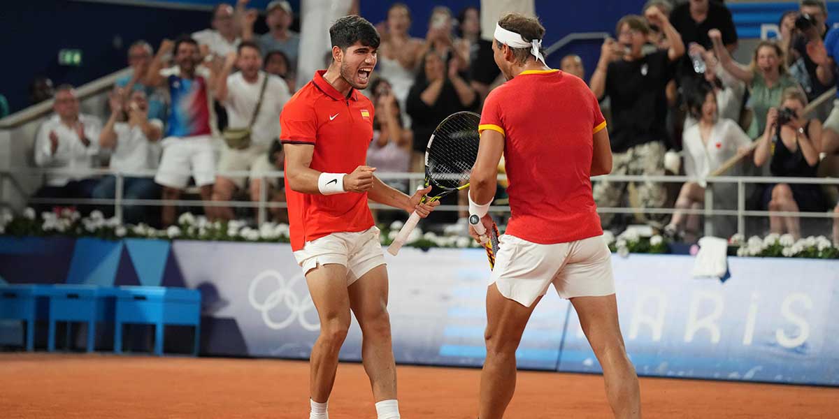 Rafael Nadal (ESP) and Carlos Alcaraz (ESP) celebrate in a men's doubles quarterfinal tennis match during the Paris 2024 Olympic Summer Games at Stade Roland Garros.