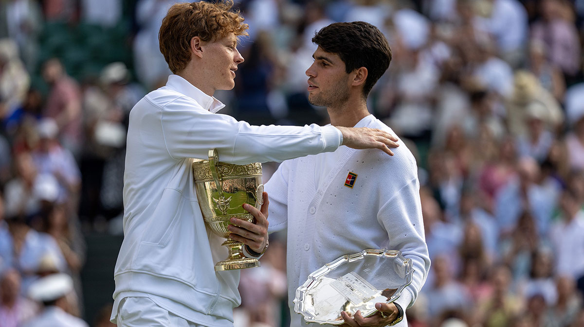 Carlos Alcaraz of Spain and Jannik Sinner of Italy pose with their trophies after the men’s singles final on day 14 at All England Lawn Tennis and Croquet Club.