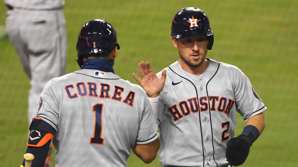 Houston Astros third baseman Alex Bregman (2) is congratulated by shortstop Carlos Correa (1) after scoring against the Los Angeles Dodgers on a single by first Houston baseman Yuli Gurriel (not pictured) in the ninth inning at Dodger Stadium.