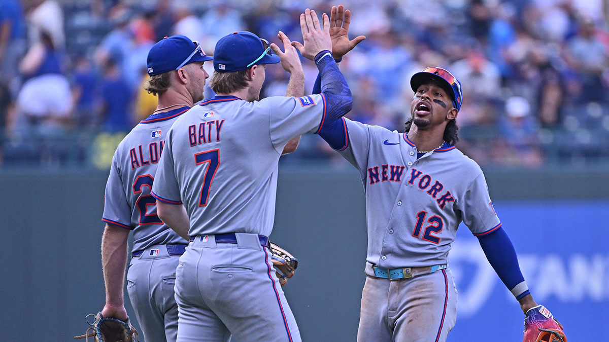 New York Mets shortstop Francisco Lindor (12) celebrates with teammates second baseman Brett Baty (7) and first baseman Pete Alonso (20) after beating the Kansas City Royals at Kauffman Stadium.