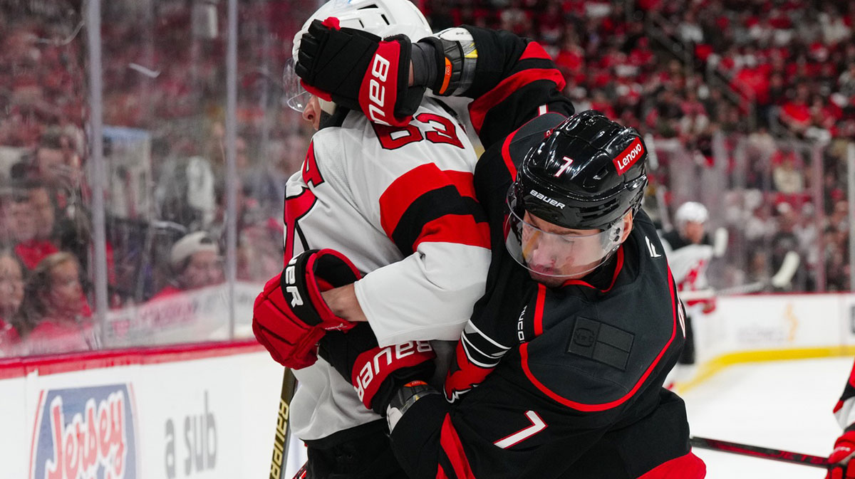 Carolina Hurricanes defenseman Dmitry Orlov (7) and New Jersey Devils left wing Jesper Bratt (63) battle during the second period in game two of the first round of the 2025 Stanley Cup Playoffs at Lenovo Center.