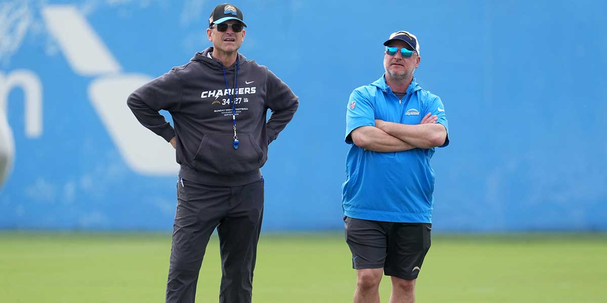 Los Angeles Chargers coach Jim Harbaugh (left) and general manager Joe Hortiz watch during offseason workouts at The Bolt.