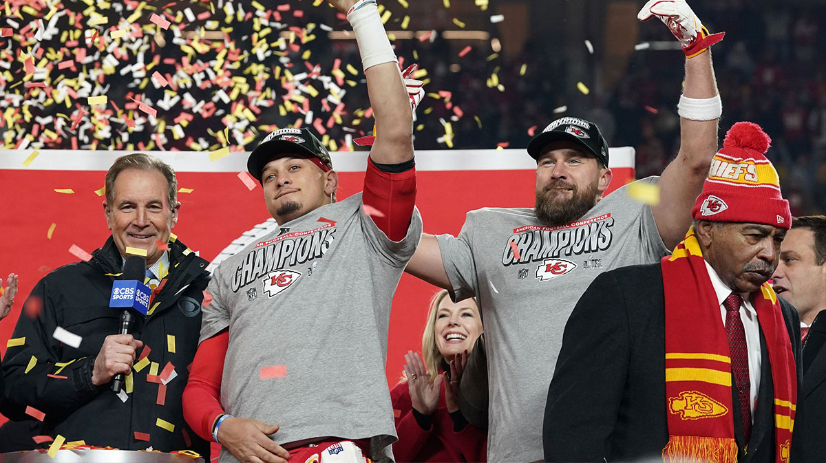 Kansas City Chiefs quarterback Patrick Mahomes (15) and tight end Travis Kelce (87) react after holding the Lamar Hunt Trophy after the AFC Championship game against the Buffalo Bills at GEHA Field at Arrowhead Stadium.