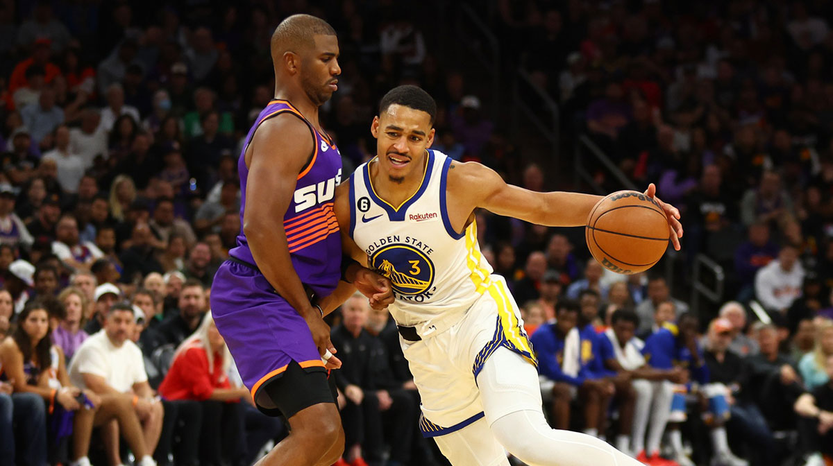 Golden State Warriors guard Jordan Poole (right) controls the ball against Phoenix Suns guard Chris Paul in the second half at Footprint Center.