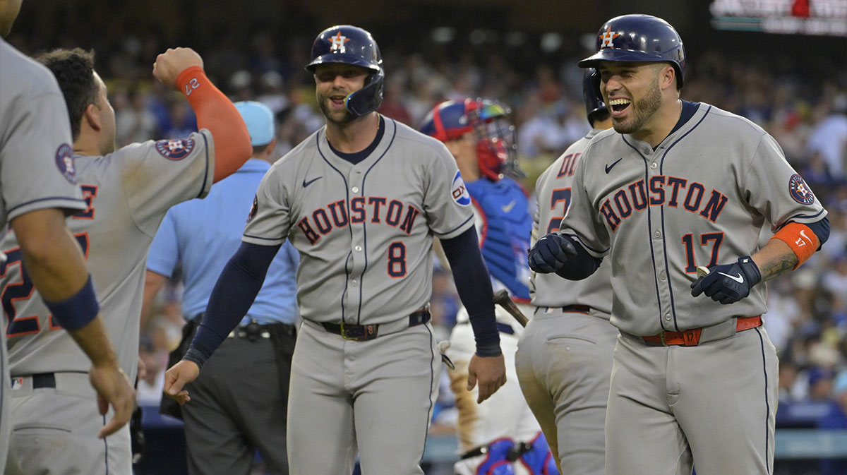 Houston Astros catcher Victor Caratini (17) celebrates left fielder Jose Altuve (27) and first baseman Christian Walker (8) after hitting a grand-slam home run in the sixth inning against the Los Angeles Dodgers at Dodger Stadium.