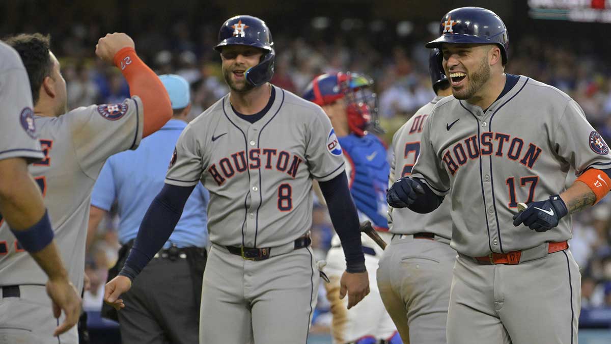 Houston Astros catcher Victor Caratini (17) celebrates left fielder Jose Altuve (27) and first baseman Christian Walker (8) after hitting a grand-slam home run in the sixth inning against the Los Angeles Dodgers at Dodger Stadium.