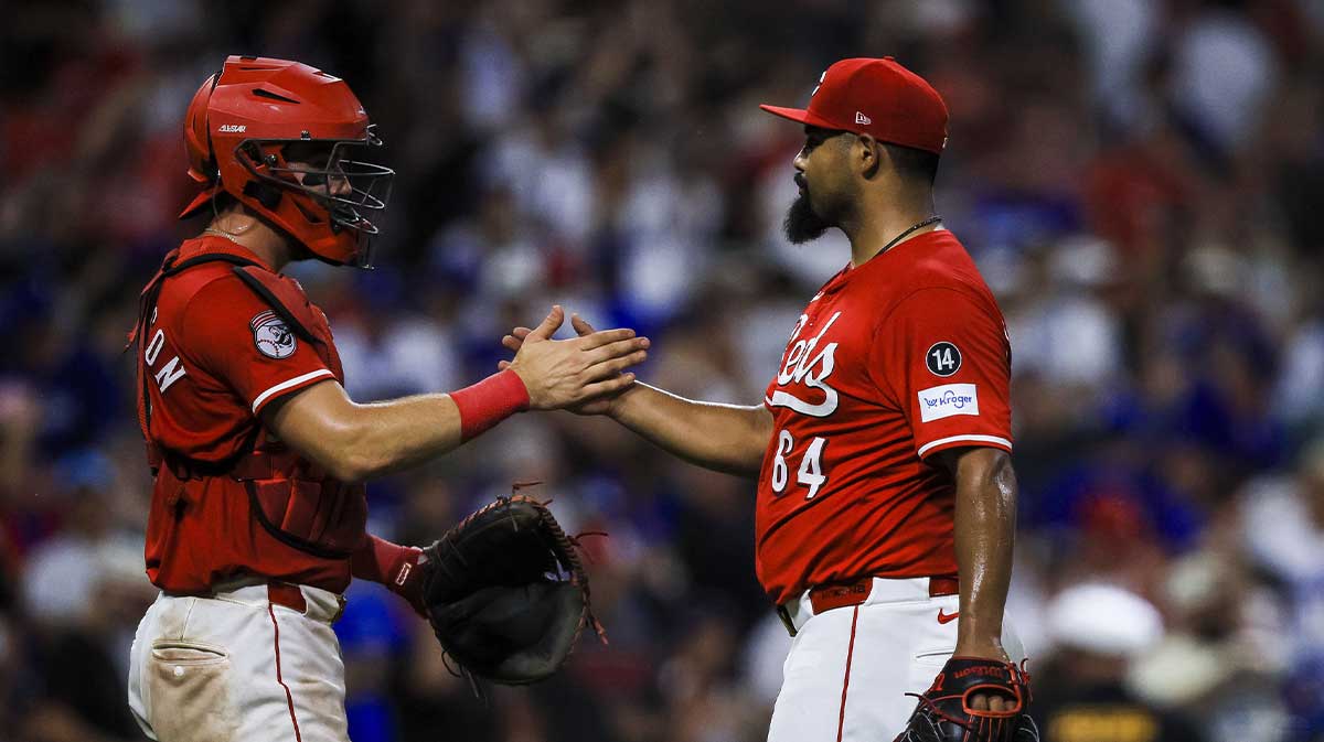 Cincinnati Reds catcher Tyler Stephenson (37) shakes hands with relief pitcher Tony Santillan (64) after the victory over the Los Angeles Dodgers at Great American Ball Park.