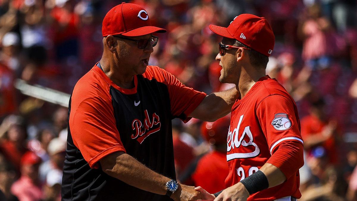 Cincinnati Reds manager Terry Francona (77) shakes hands with outfielder TJ Friedl (29) after the victory over the Colorado Rockies at Great American Ball Park.