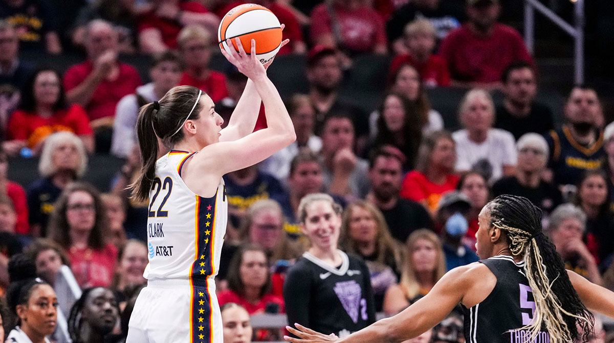 Indiana Fever guard Caitlin Clark (22) attempts a 3-pointer against Golden State Valkyries forward Kayla Thornton (5) on Wednesday, July 9, 2025, during a game between the Indiana Fever and the Golden State Valkyries at Gainbridge Fieldhouse in Indianapolis.